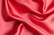 © Sameh - texture of flowing silk fabric with soft folds, satin material, red cloth background