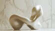 © ABIDZAR ALFAREZ - Abstract beige sculptural chair against marble.