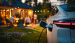 © Dusit - A modern electric car charging in suburban garden during lively evening gathering. Friends enjoy warm atmosphere with lights and laughter