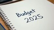 © Aimi - Handwriiten text of ' Budget 2025'.