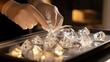 © kittikunfoto - Expert jeweler handles exquisite diamonds with care, showcasing luxury gemstones and precision craftsmanship for high-end jewelry enthusiasts worldwide.