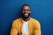 © Dzikrul Husnani - Portrait of handsome African-American man wearing glasses and looking at camera smiling while posing against deep blue background, copy space