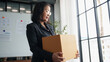 © Wanda - Senior business asian woman mature retire from work elderly employee packing the box and leaving the office