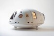 © Thedinindu - A white spacecraft capsule, seemingly a prototype, rests on legs against a white backdrop.