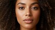 © IbragimovN - Close-up portrait of a woman with natural curly hair and radiant skin