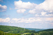 © Cavan - Windmill Renewable Energy Turbines Spinning on a Tree Covered Mountain