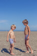 © Cavan - Brothers Bonding on the Beach Under a Clear Sky