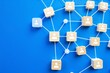 © PlanetOfVectors - Wooden blocks with user icons connected by white lines on a blue background. Concept of communication, networking, teamwork, and collaboration. Ai generative