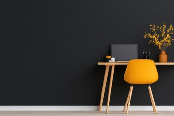 Modern workspace setup featuring laptop, yellow chair, and decorative flowers on wooden desk against black wall