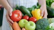 © EchoFrame - Fresh Organic Vegetables and Fruits in a Wooden Basket Held by Hands