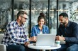 © PlanetOfVectors - A group of three diverse professionals collaborating around a laptop, seated at a table in a modern office. Bright and welcoming atmosphere. Ai generative