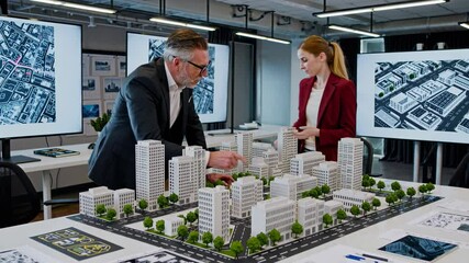 Leinwandbilder - Professionals collaborate on urban design project using architectural model in modern office space