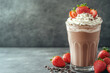 © StokHunt - Glass of chocolate milkshake topped with whipped cream and fresh strawberries, offering a sweet and refreshing treat