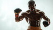 © fangphotolia - Powerful Boxer: A muscular Black boxer, sweat glistening on his powerful physique, delivers a fierce punch. The dramatic lighting and intense focus capture his determination and strength.