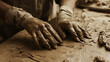 © Fonlinepix - A sculptor working with clay, their hands covered in materials, showcasing the tactile nature of creativity.