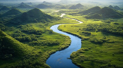 Wall Mural - Serene river winding through vibrant green hills in a tranquil landscape during daytime