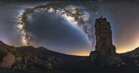 Wall Mural - beautiful night sky with stars and the milky way over a rocky mountain, the silhouette of a person s