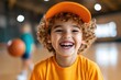 © Lens Legacy - Happy young boy with curly hair enjoys basketball practice in a vibrant gym setting on a sunny day