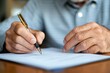 © Lens Legacy - Elderly person engages in thoughtful writing while seated at a wooden table, showcasing dedication and focus on a sunny afternoon