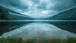© Nawarit - Cloudy sky over a tranquil lake, reflections of the clouds in the still water, moody and peaceful, nature at its calmest