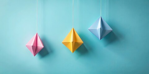 Wall Mural - pastel origami decorations hanging against a light blue background