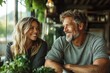 © Lens Legacy - Couple enjoying a cozy moment together in a charming cafe surrounded by lush plants and warm sunlight