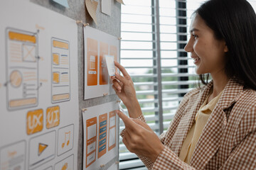 ux developer and ui designer brainstorming about mobile app interface wireframe design in the office, website designer, creative planning phone app development template