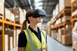 © Moopingz - Female warehouse worker wearing VR headset and safety vest, exploring augmented reality technology in logistics.