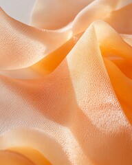 Leinwandbilder - Close-up of peach-colored fabric with soft, flowing folds and subtle texture, illuminated by soft light.
