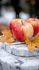 Three red apples sitting on top of a marble table