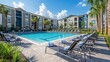 © milenialdesastudio - Resort-style pool with lounge chairs and apartment buildings in background.