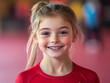 © Bohdan - Smiling girl in a gymnastics outfit during practice