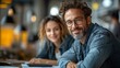 © siyons - Man and woman working together in a modern office