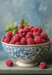 Wall Mural - Fresh raspberries in a decorative bowl with floral design on a rustic background