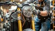 © Wilasinee - Skilled Motorcycle Mechanic Closely Examining and Repairing the Throttle and Cables of a Motorcycle in a Well Equipped Bike Workshop or Garage Setting