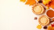 © julio - Autumn-themed table setting with pies, leaves, and a drink.