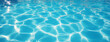 © 수동 김 - Close-up of clear blue water in a swimming pool, with sunlight reflection creating a textured background. Top view.