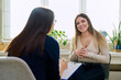 © Valerii Honcharuk - Happy young woman at therapy with female professional psychologist