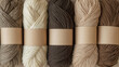 © TRATATA - Chocolate mousse yarn skeins with blank labels for mockup on neutral beige background. Natural cotton yarn in rolls. Knitting and craft design