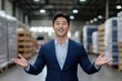 © LifeMedia - Confident businessman smiling and presenting in a modern warehouse filled with products and organized shelves
