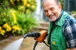 © LifeMedia - Smiling gardener enjoys sunny day while using pressure washer in vibrant backyard