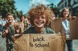 © LifeMedia - Joyful students celebrate the return to school with handmade signs on a sunny day in the city