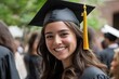 © jambulart - Smiling graduate in cap and gown, golden tassel.