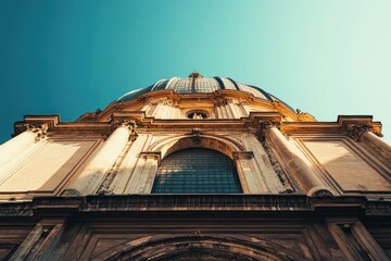 Poster - Low angle view of a grand cathedral dome and facade against a clear blue sky.