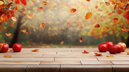 Poster - Red apples on wooden table with falling autumn leaves and blurred background.