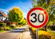 © Danicha - 30 KPH Speed Limit Sign in Residential Area - Clear Day Stock Photo