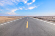 © ABCDstock - Asphalt highway road and desert with beautiful sky clouds natural landscape in Xinjiang, China. Outdoor road background.
