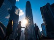 © BerkahStock - Silhouetted businesspeople conversing amidst skyscrapers under a bright sun.