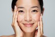 © velikiyzayats - Radiant Asian Woman Smiling with Hands on Face, Perfect for Skincare and Beauty Product Advertising