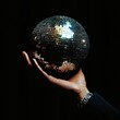 © MK - Person holding a disco ball